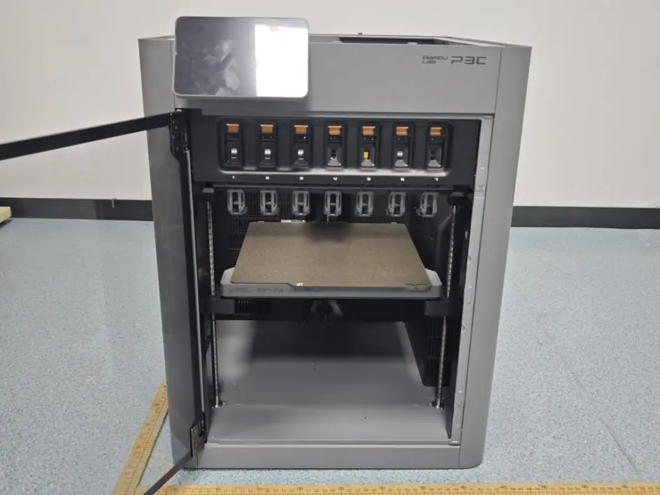 Bambu Lab P3C with its door open, showing seven numbered docks above the build plate